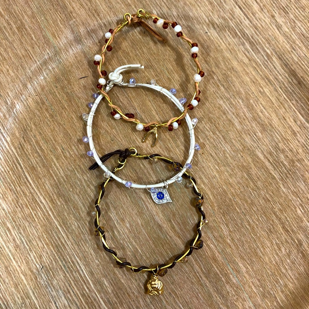 NWOT HANDMADE set of 3 leather, crystal, and wire bracelets with charms.